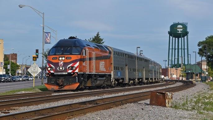 A train riding through the town of Elmwood Park. 